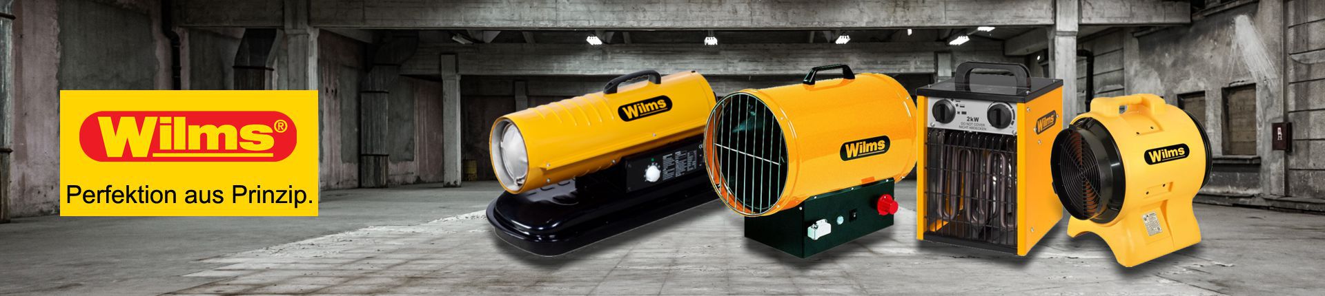 Bild Drei Wilms Heizgeräte und ein Ventilator in einer Industriehalle stehend