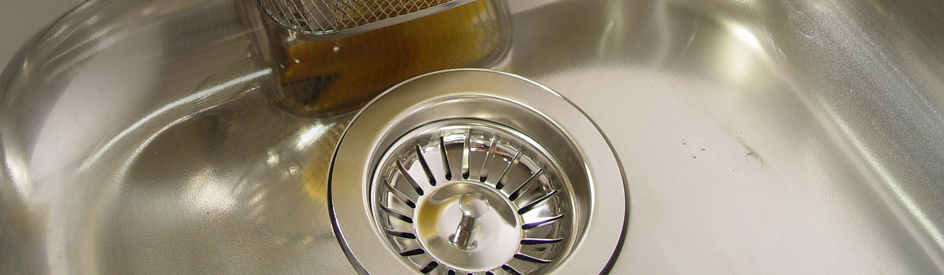 Silberfarbener Siebeinsatz in einem Spülbecken bild